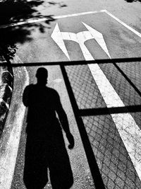 High angle view of shadow of person on street