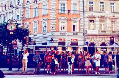 Group of people walking on city street