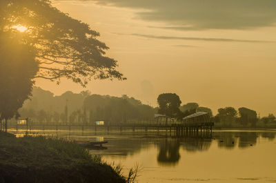 Scenic view of lake against sky during sunset