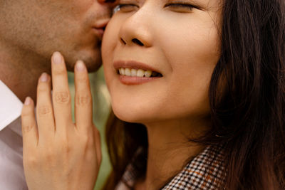 Close-up of young couple hugging