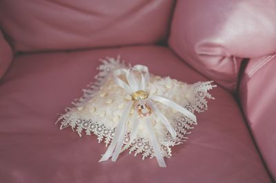 Close-up of wedding rings on sofa