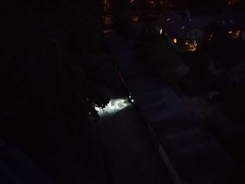 High angle view of illuminated street amidst buildings at night