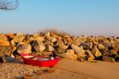 Scenic view of rocks on beach against clear sky