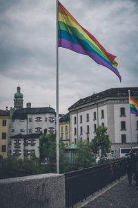 Rainbow over buildings in city against sky