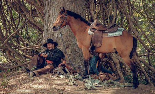 Men and horse in forest