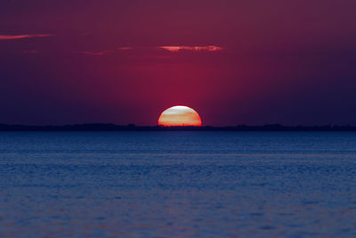 Scenic view of sea against romantic sky at sunset