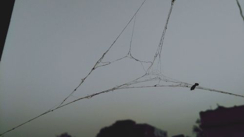 Low angle view of electricity pylon against sky