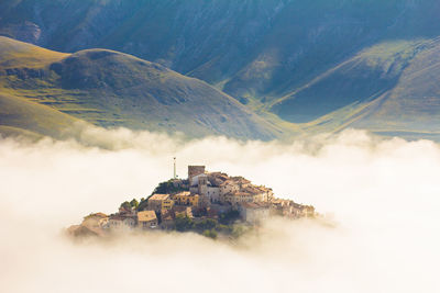 Buildings on mountain against sky