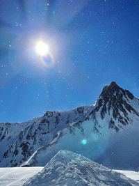 Scenic view of snowcapped mountains against sky at night