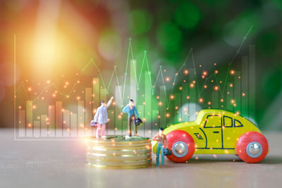 Digital composite image of illuminated toy car at night