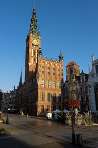 Low angle view of buildings against clear blue sky