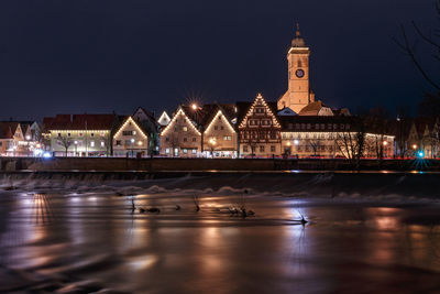 Reflection of illuminated buildings in city at night