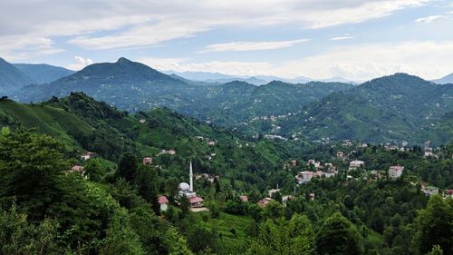 High angle view of townscape and mountains against sky