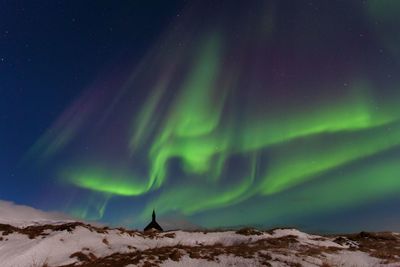 Scenic view of landscape against sky at night