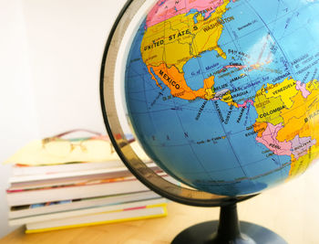 Countries and continents with colorful map on globe with books in the background. education concept.