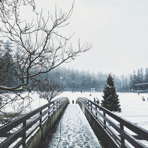 Bridge over canal against sky during winter