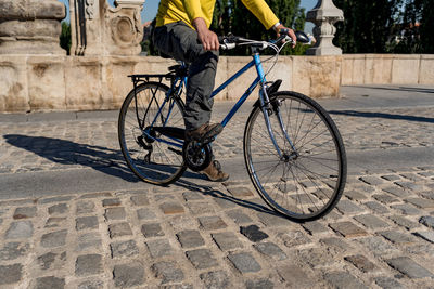 Unrecognizable man riding bicycle in the city