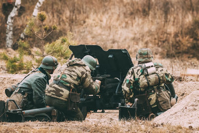 Rear view of siblings in field