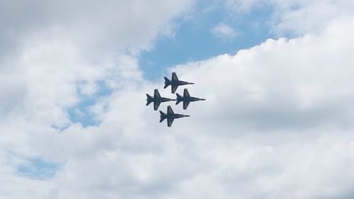 Low angle view of airplane flying against sky