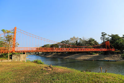 Bridge over river against clear blue sky at vang vientiane,lao.