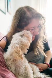 Close-up of smiling woman with dog