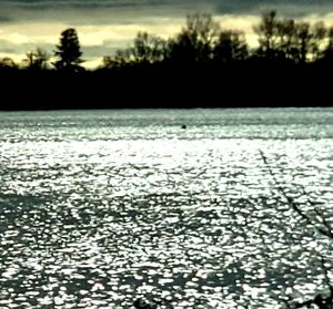 Scenic view of lake against sky during winter