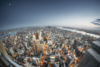 Aerial view of illuminated cityscape against sky