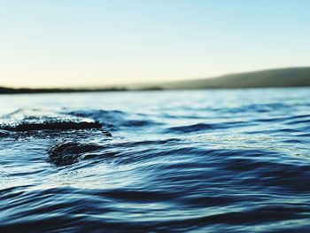 Surface level of sea against clear sky