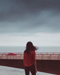 Rear view of woman standing on beach