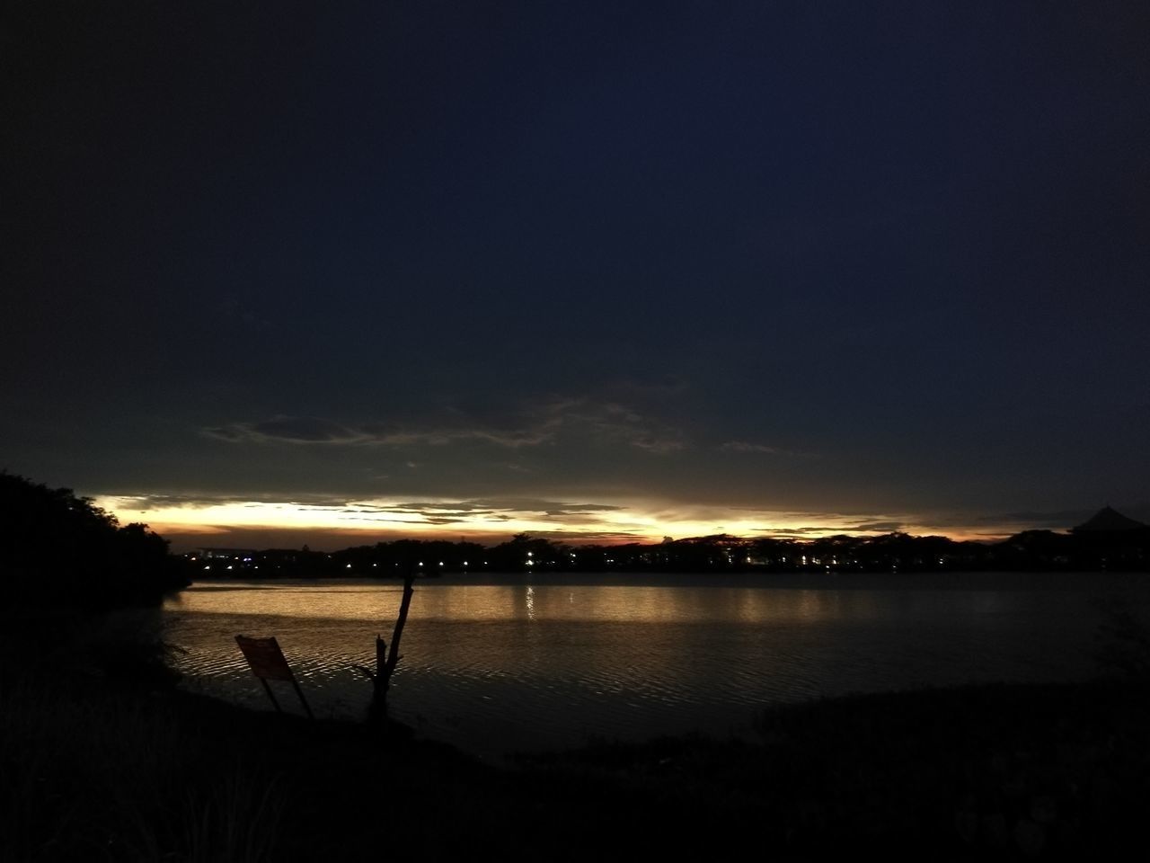 ILLUMINATED SEA AGAINST SKY DURING SUNSET