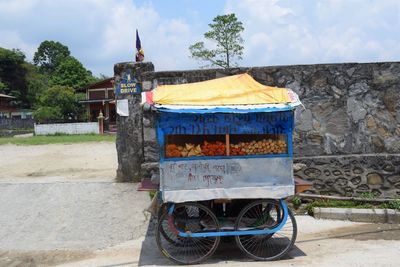 Built structure by road against sky