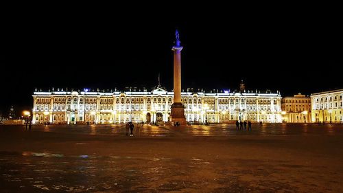 Illuminated building against sky at night