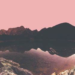 Low angle view reflection of mountain in lake during sunset