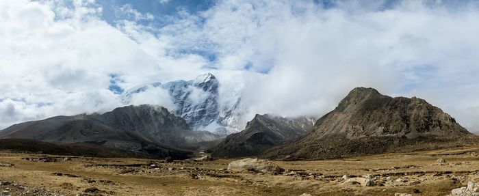 Scenic view of mountains against cloudy sky