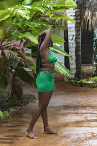 Rear view of woman standing on footpath