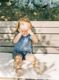 Cute girl sitting on bench