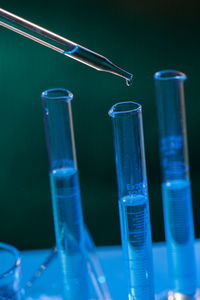 Close-up of blue glass against black background