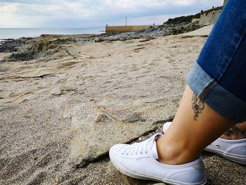 Low section of woman at beach