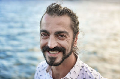 Portrait of smiling mid adult man in sea