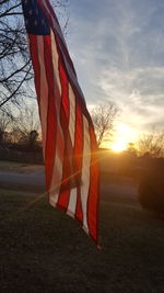 Close-up of flag against sky during sunset