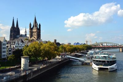 Boats in river with buildings in background