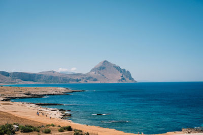 Scenic view of sea against clear blue sky