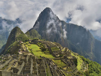 Aerial view of mountain range against cloudy sky