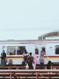 Blurred motion of train at railroad station against sky