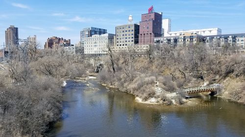 River amidst buildings against sky