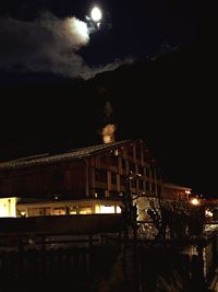 Illuminated buildings against sky at night