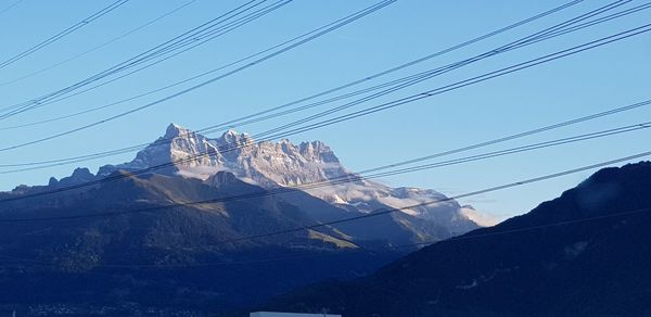 Low angle view of snow covered mountain against sky