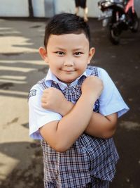 Portrait of cute boy standing outdoors