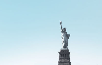 Low angle view of statue against blue sky