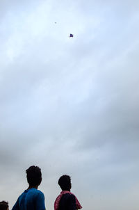 Low angle view of man jumping in sky